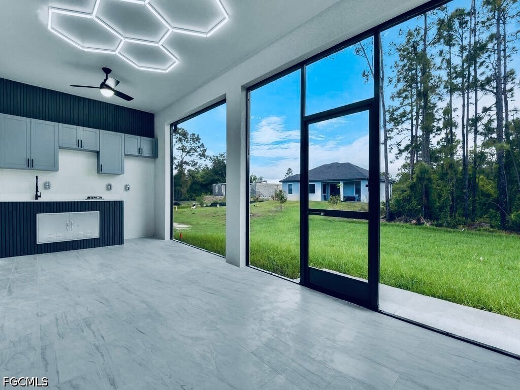3517 2nd Street Southwest Lehigh Acres, FL 33976 - Photo 7 of 28 a view of an empty room with a fireplace and a large window
