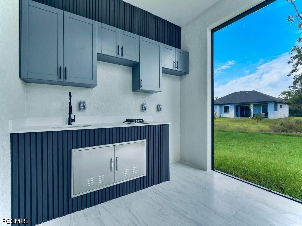 3517 2nd Street Southwest Lehigh Acres, FL 33976 - Photo 8 of 28 a view of a kitchen with cabinets and a wooden floor