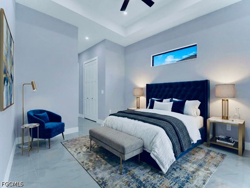 3517 2nd Street Southwest Lehigh Acres, FL 33976 - Photo 10 of 28 a spacious bedroom with a bed a couch and a chandelier