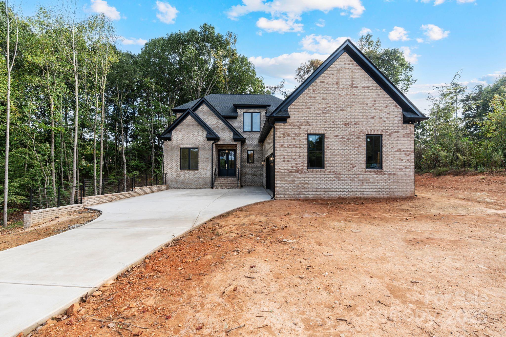 a view of a house with a yard and pathway