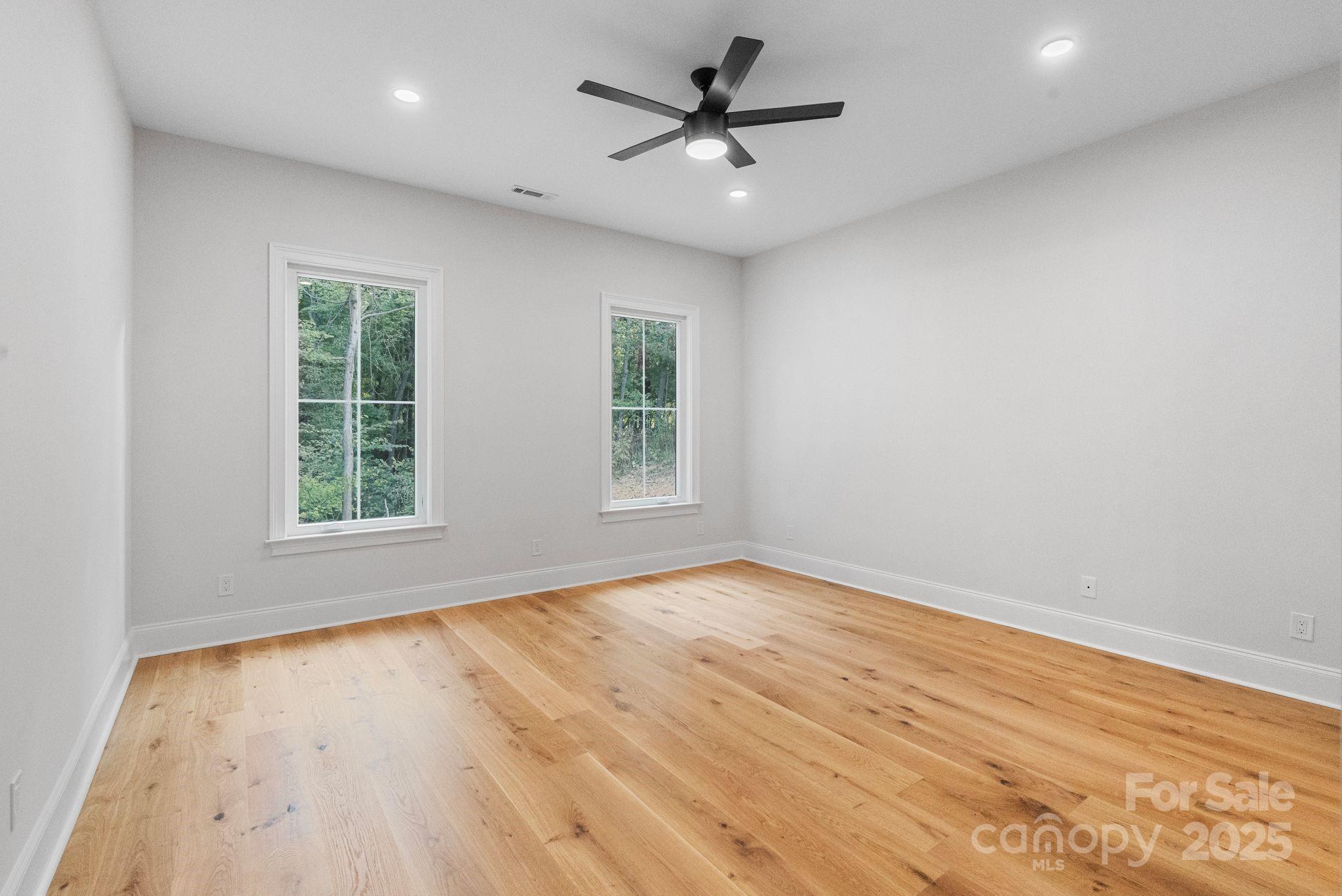3204 Chancellor Lane Monroe, NC 28110 - Photo 16 of 48 a view of empty room with wooden floor and fan