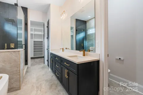 a bathroom with a double vanity sink and mirror