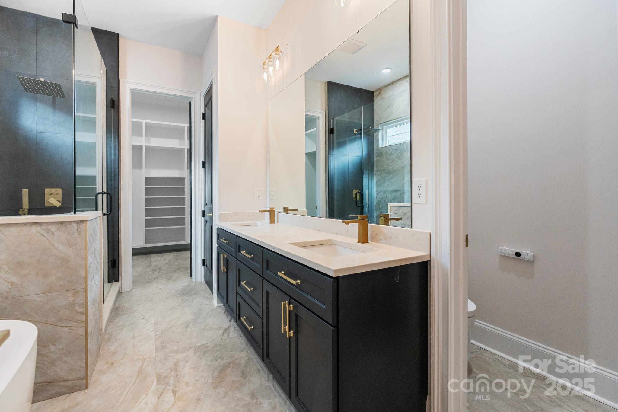 3204 Chancellor Lane Monroe, NC 28110 - Photo 18 of 48 a bathroom with a double vanity sink and mirror