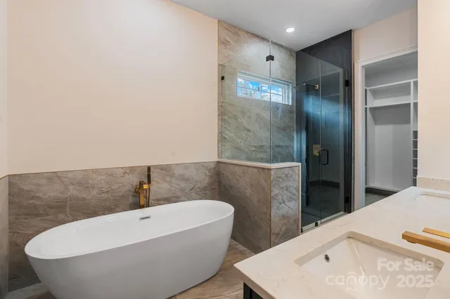 a bathroom with a bathtub and shower