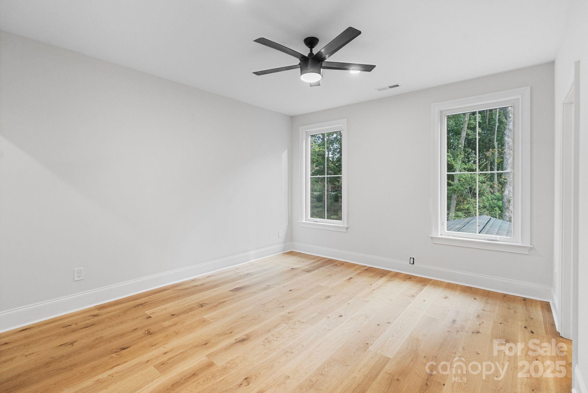 3204 Chancellor Lane Monroe, NC 28110 - Photo 27 of 48 an empty room with wooden floor and windows