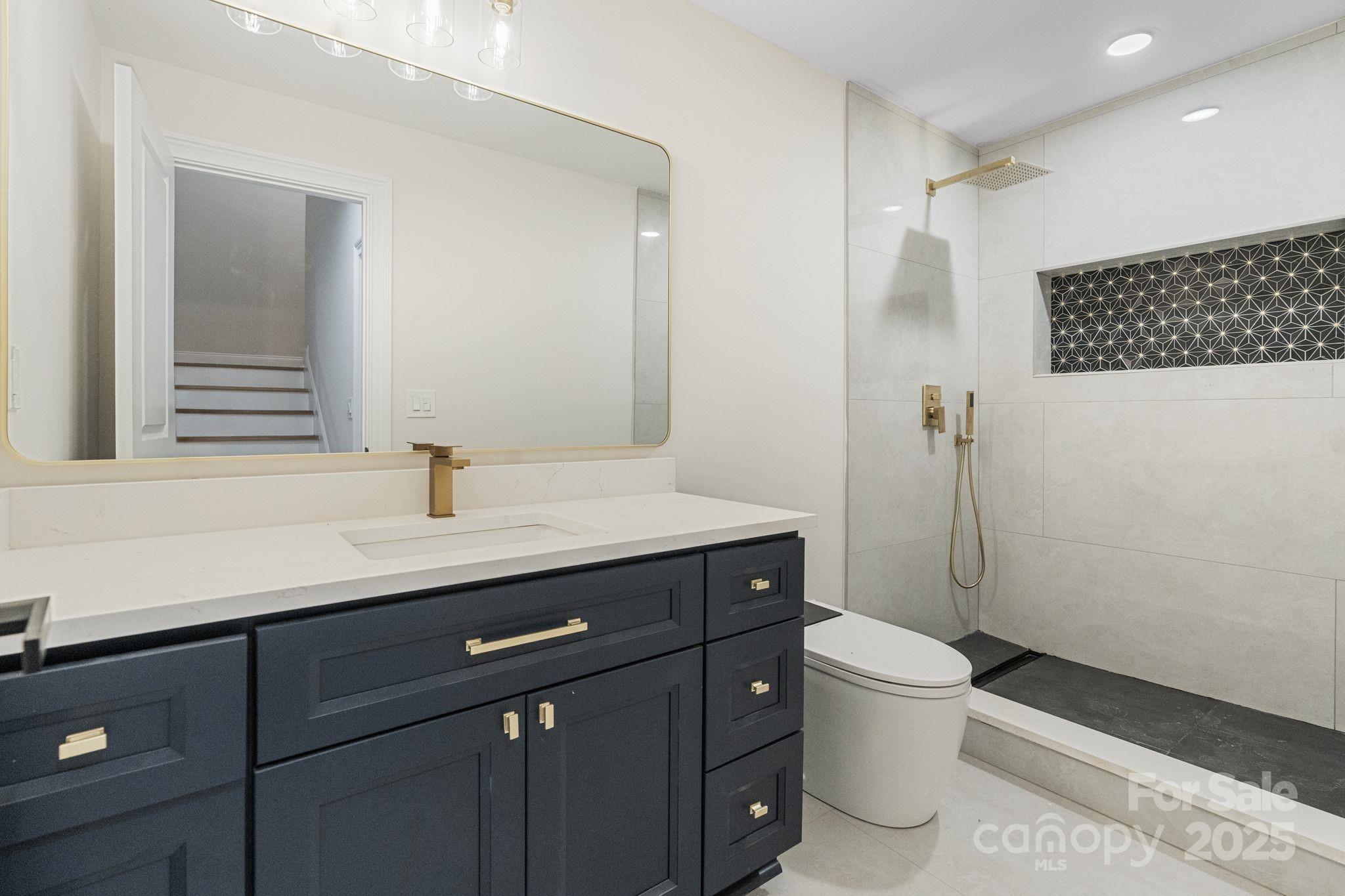 3204 Chancellor Lane Monroe, NC 28110 - Photo 36 of 48 a bathroom with a sink a toilet a mirror and shower