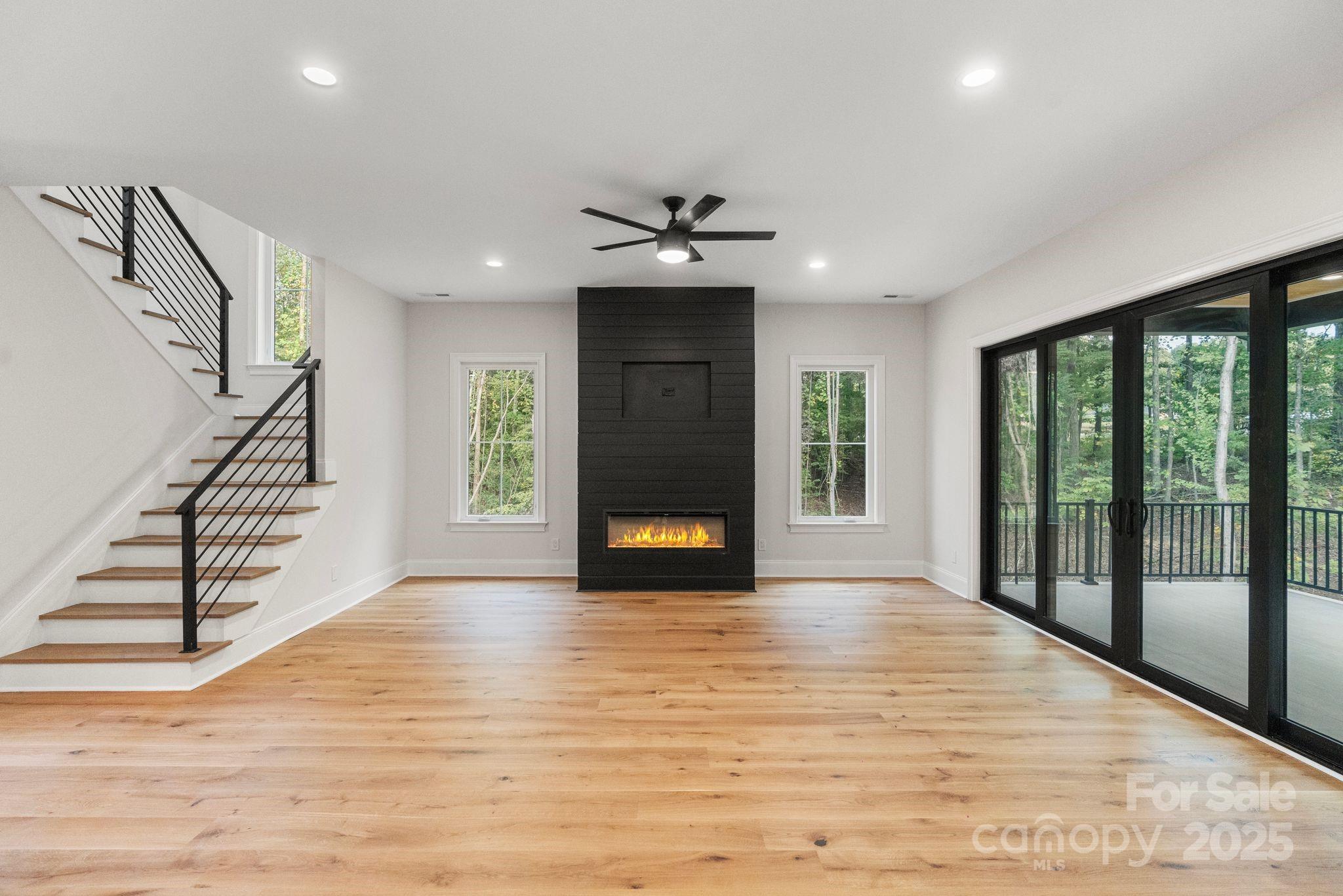 3204 Chancellor Lane Monroe, NC 28110 - Photo 4 of 48 a view of an empty room with wooden floor fireplace and a window