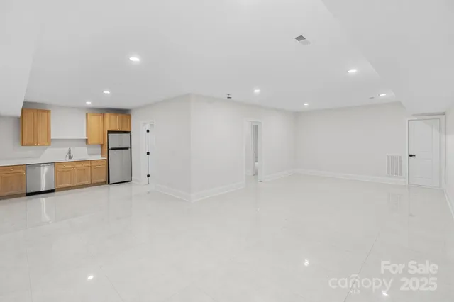 a view of a kitchen with a sink and a refrigerator