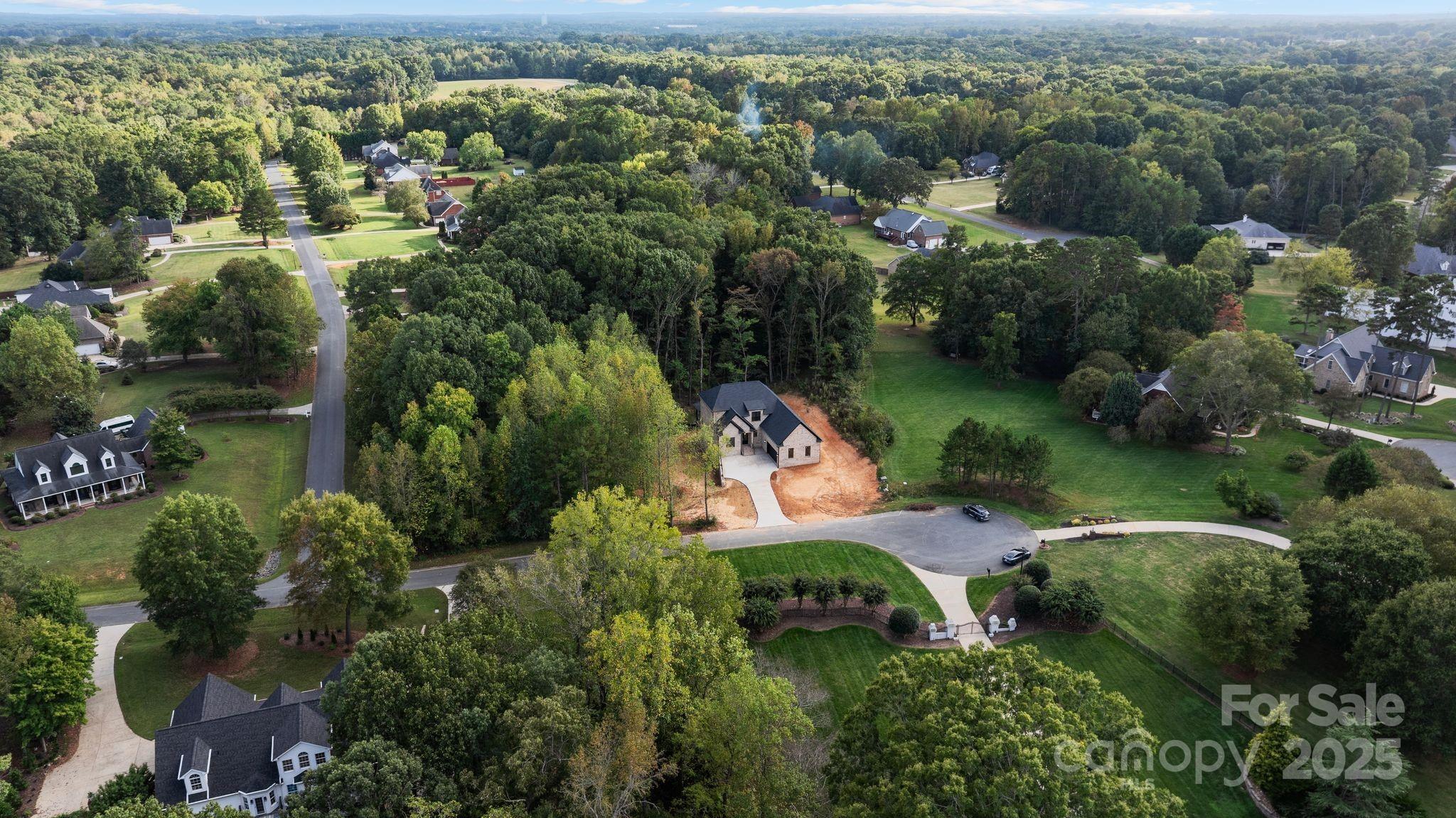 3204 Chancellor Lane Monroe, NC 28110 - Photo 46 of 48 an aerial view of residential houses with outdoor space and trees