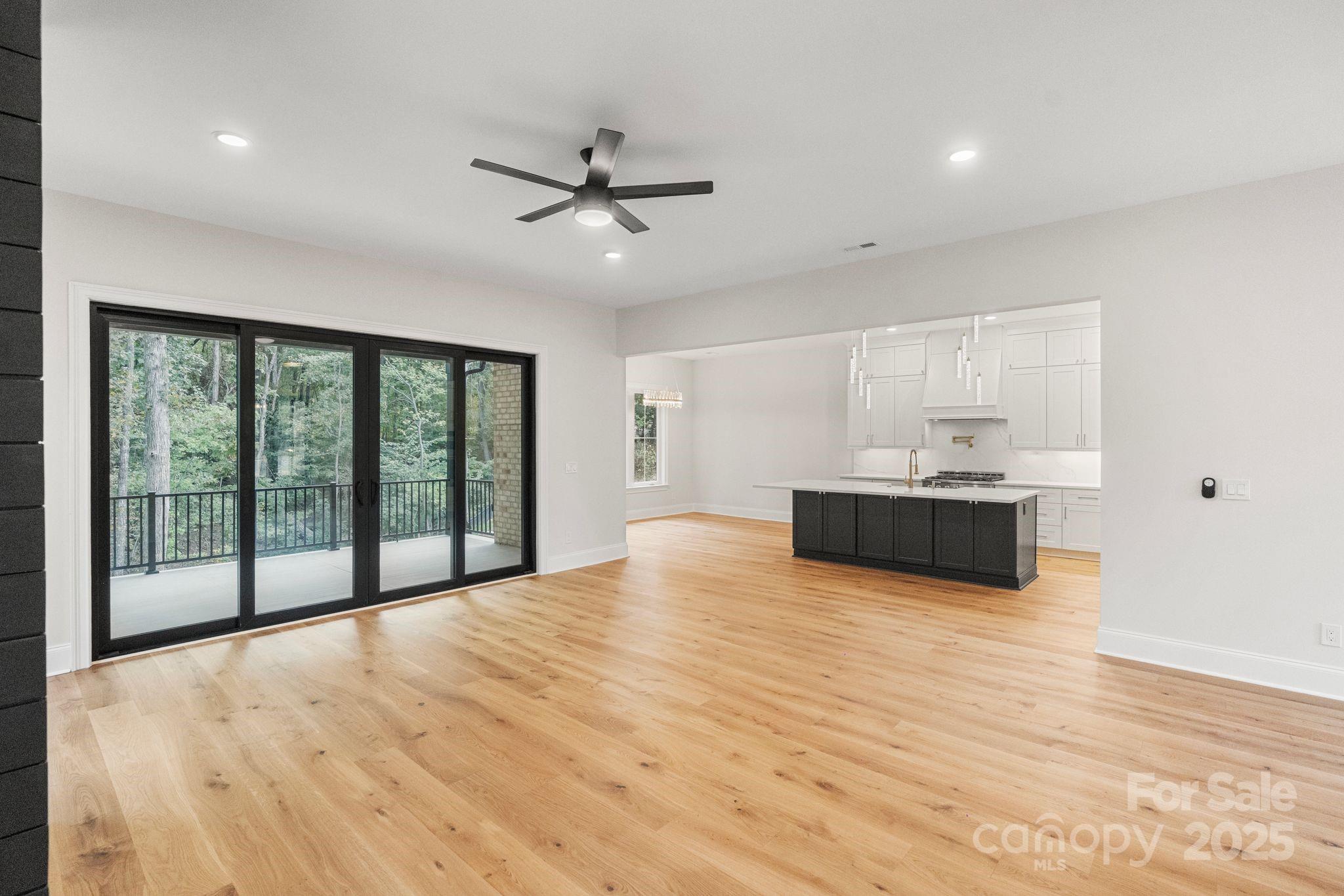 3204 Chancellor Lane Monroe, NC 28110 - Photo 6 of 48 a view of an empty room with a window and wooden floor