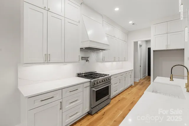 a kitchen with white cabinets stainless steel appliances and sink