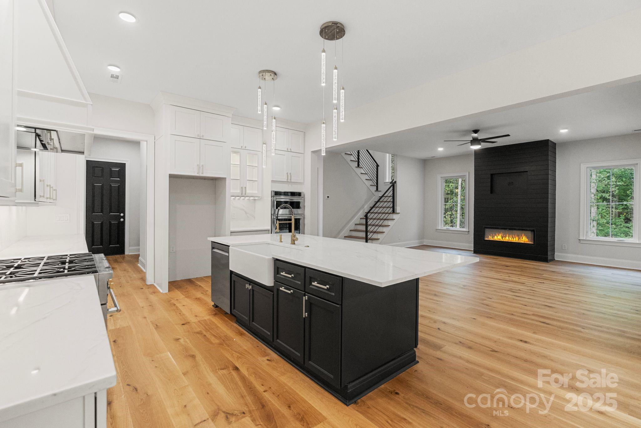 3204 Chancellor Lane Monroe, NC 28110 - Photo 10 of 48 a large kitchen with stainless steel appliances a large counter top a stove a sink and a refrigerator
