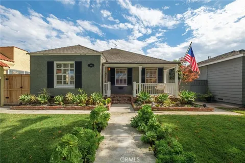 a front view of house and yard with green space