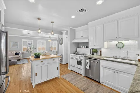 a kitchen with a sink stove and cabinets