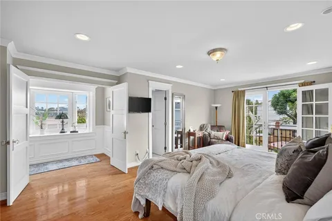 a bedroom with a large bed and a large window