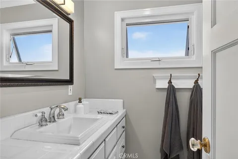a bathroom with a sink mirror and vanity