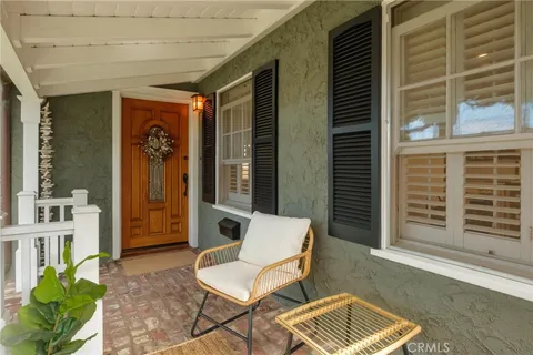 a balcony with furniture and a potted plant