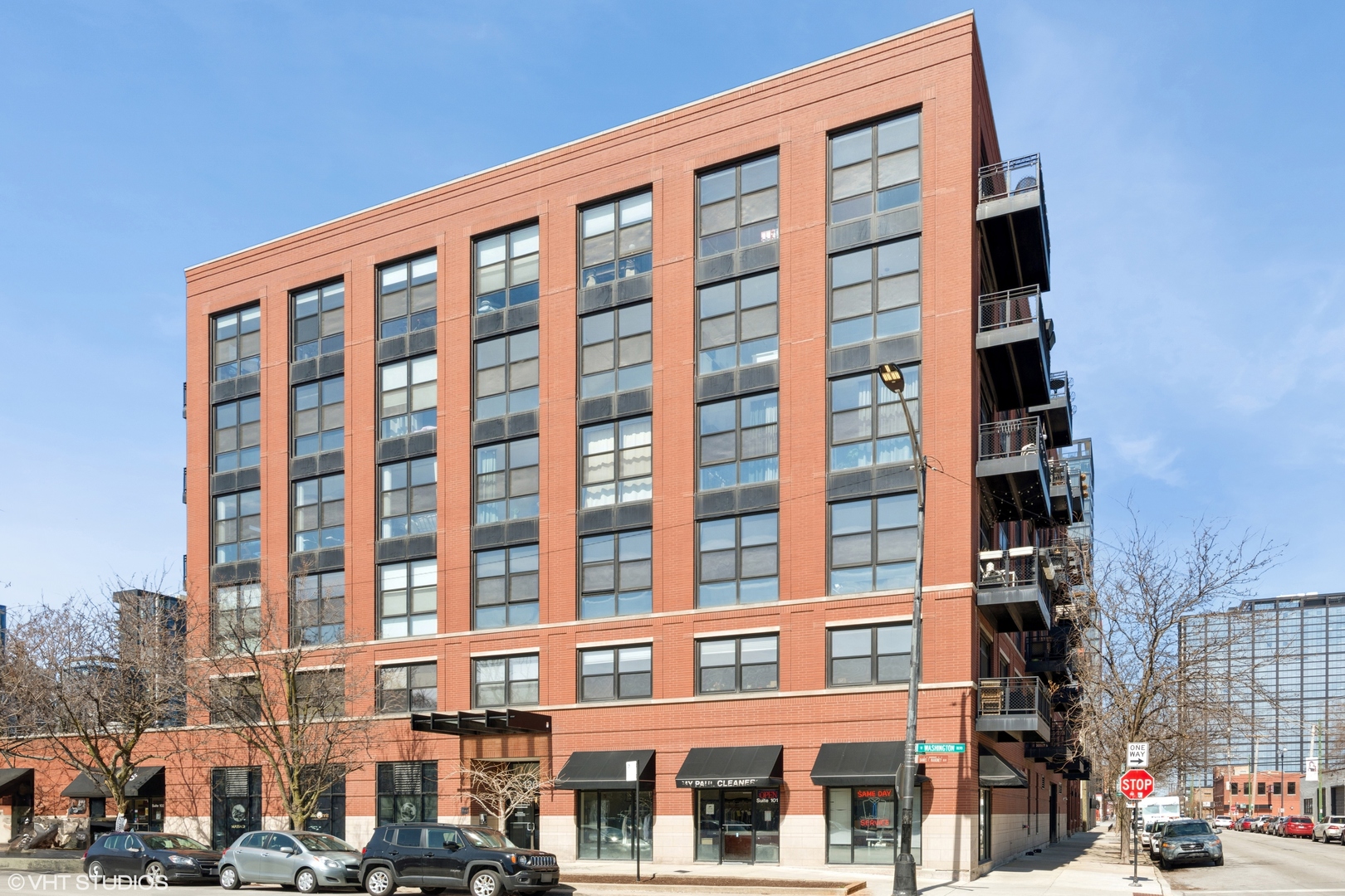 1260 West Washington Boulevard, Unit 504 Chicago, IL 60607 - Photo 1 of 23 a front view of a building with lot of street