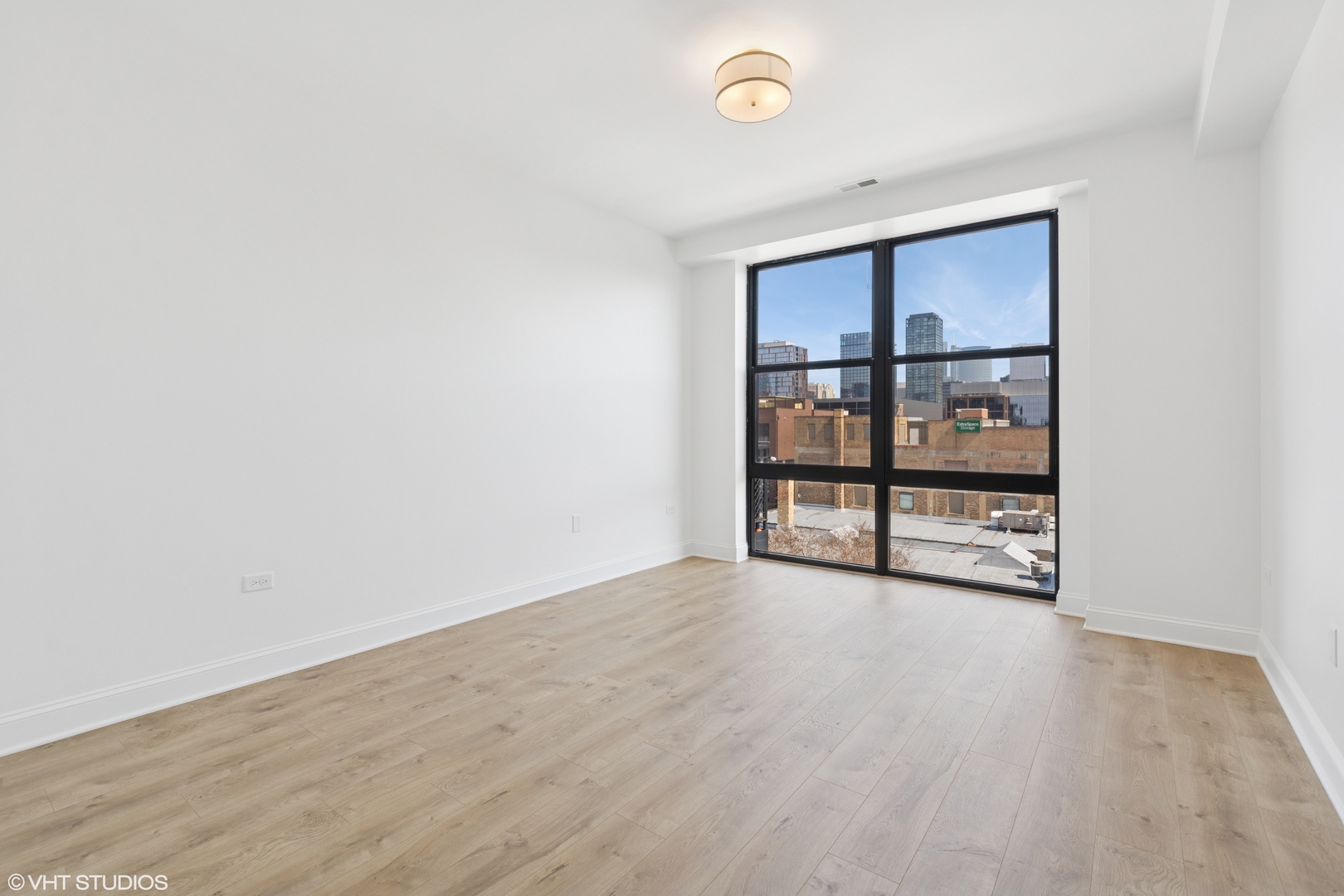 1260 West Washington Boulevard, Unit 504 Chicago, IL 60607 - Photo 11 of 23 wooden floor in an empty room with a window