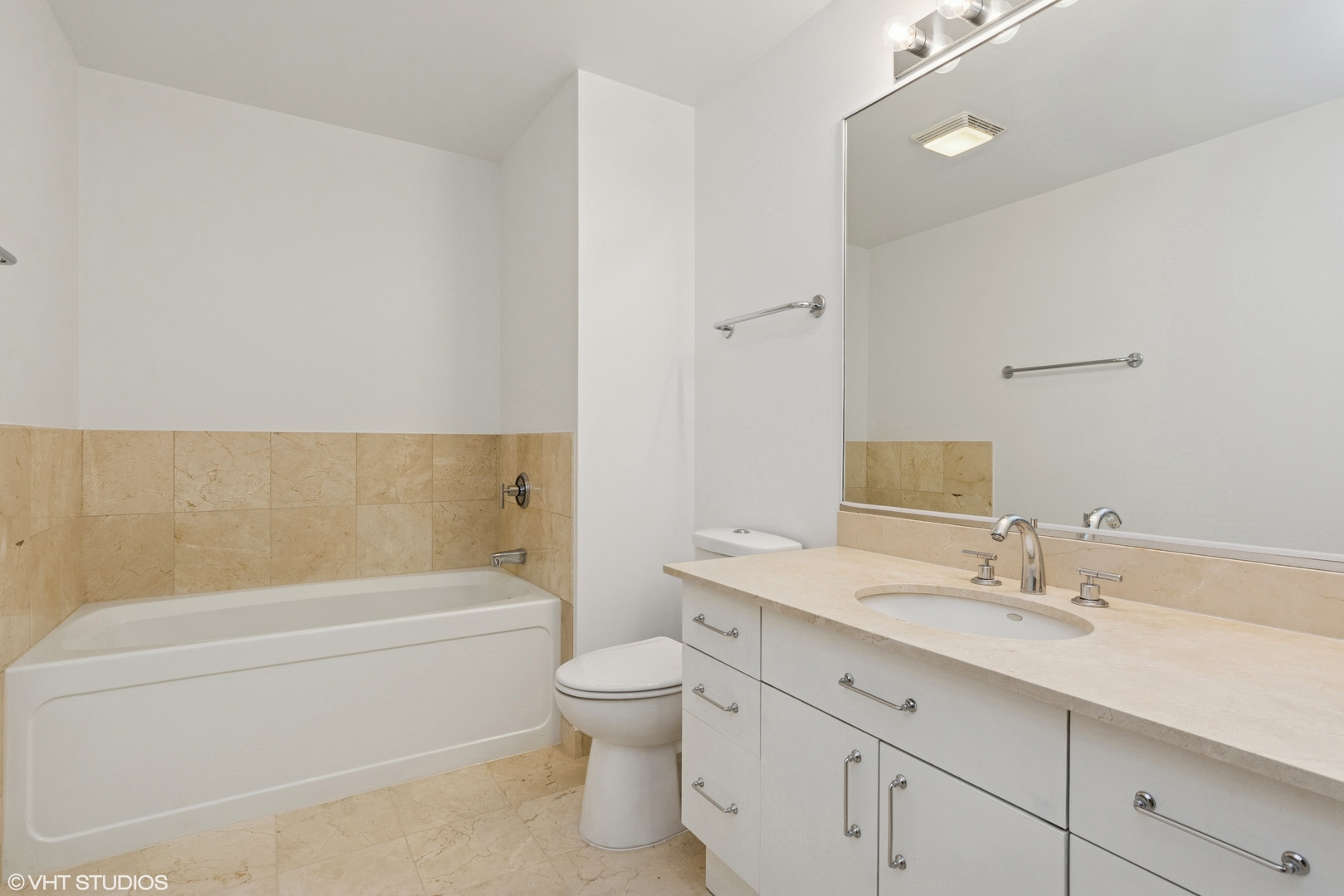 1260 West Washington Boulevard, Unit 504 Chicago, IL 60607 - Photo 14 of 23 a bathroom with a bathtub shower sink vanity mirror and toilet