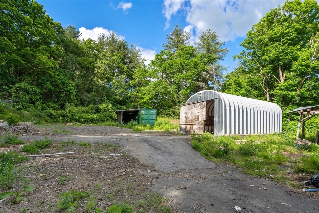 190 Ware Road Warren, MA 01092 - Photo 15 of 17 a view of a house with a yard and large trees