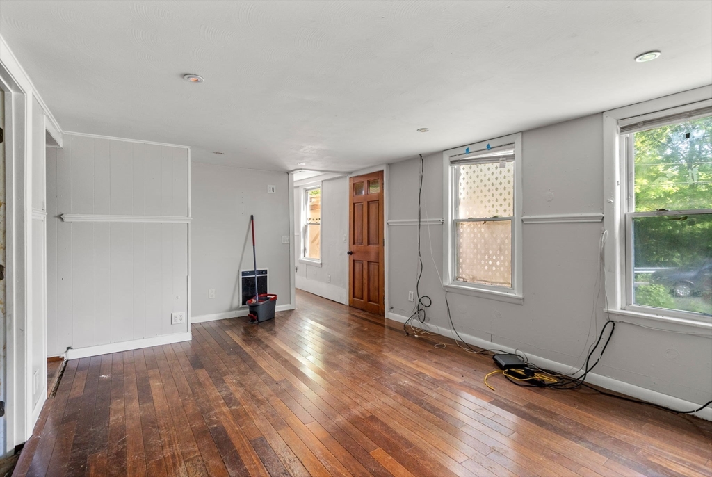 190 Ware Road Warren, MA 01092 - Photo 8 of 17 an empty room with wooden floor and windows