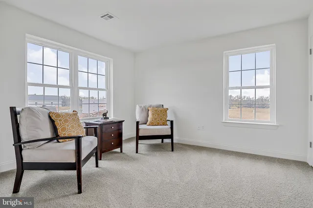 a view of a livingroom with furniture and a window