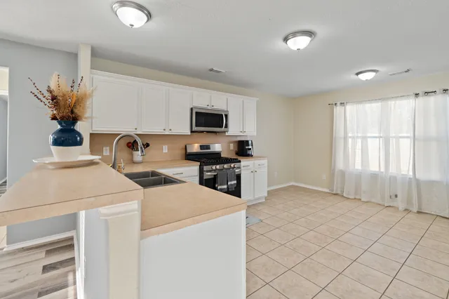a kitchen that has a sink and a stove