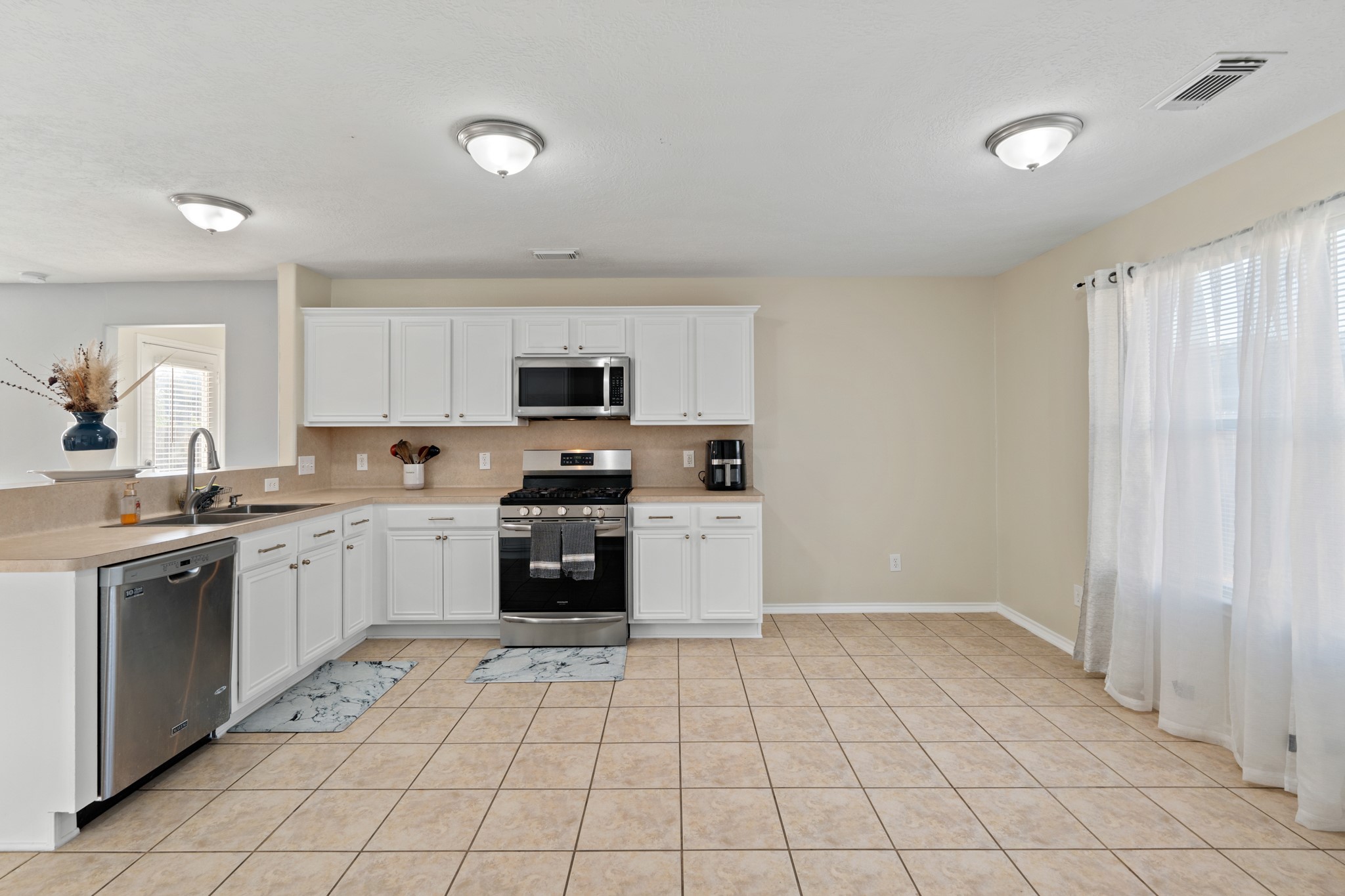 20807 Carsen Spring Court Katy, TX 77449 - Photo 13 of 31 a kitchen with a stove top oven sink and cabinets