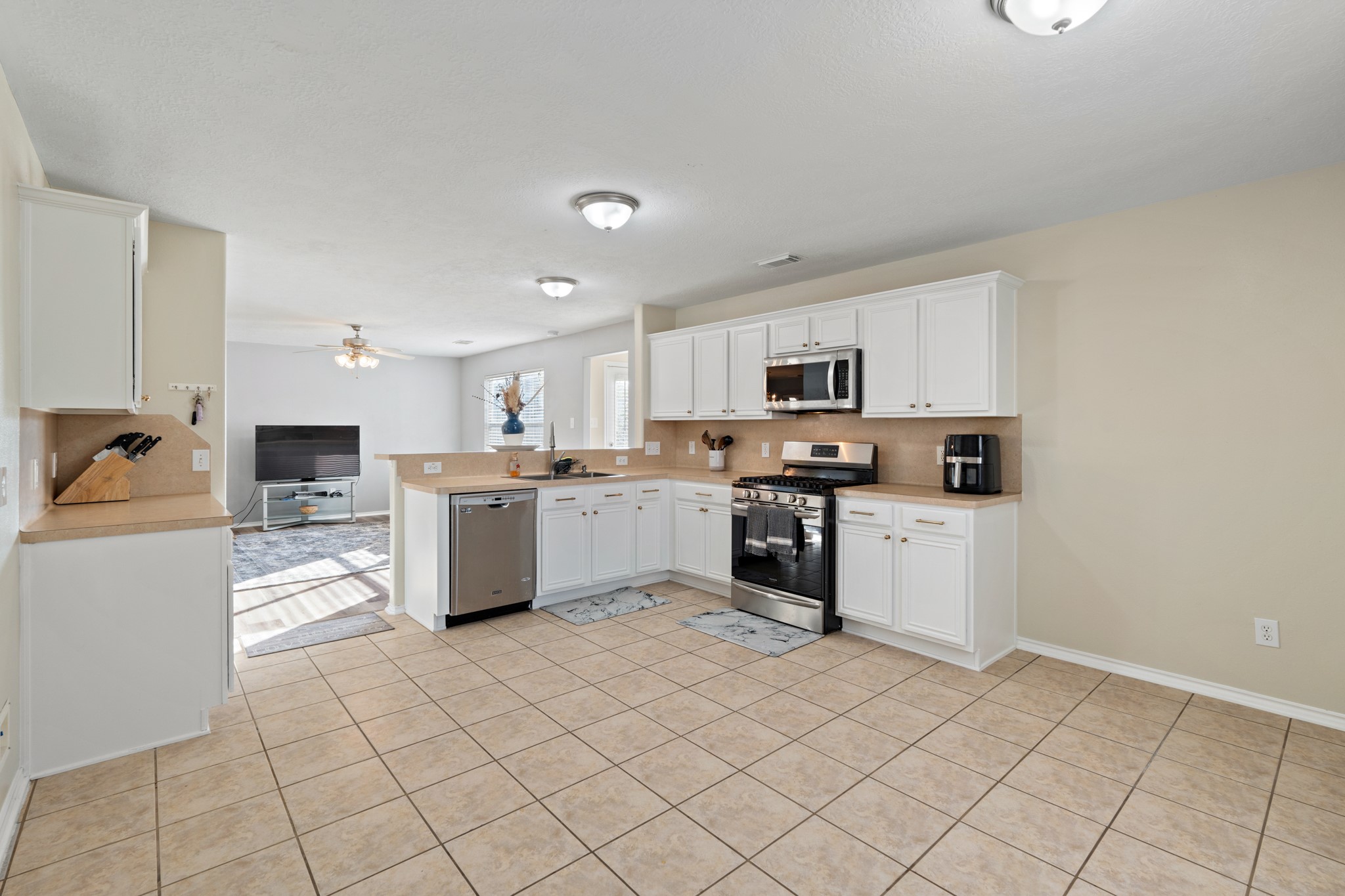 20807 Carsen Spring Court Katy, TX 77449 - Photo 14 of 31 a kitchen with stainless steel appliances a refrigerator sink and microwave