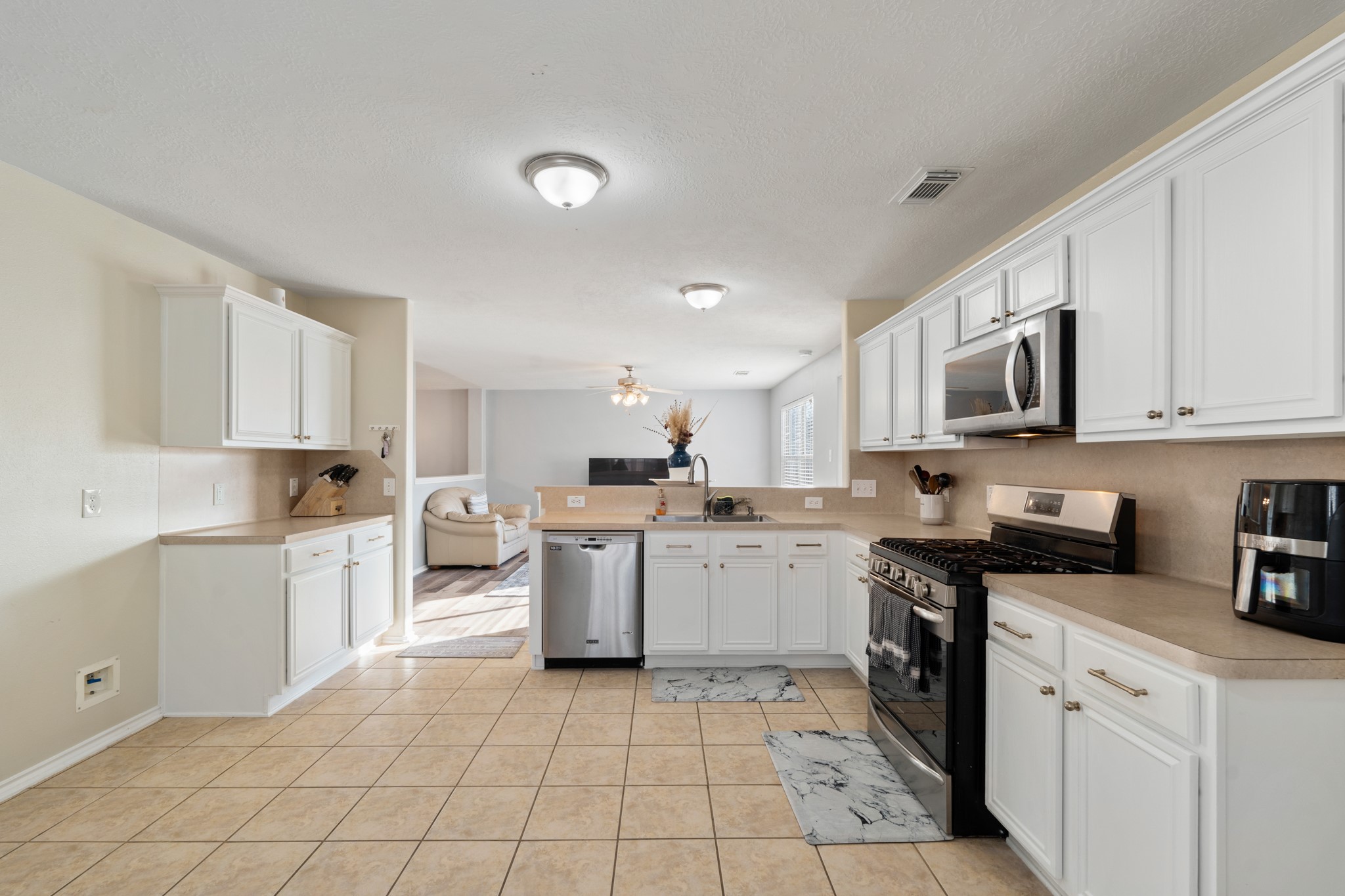 20807 Carsen Spring Court Katy, TX 77449 - Photo 15 of 31 a kitchen with a sink white cabinets and white appliances