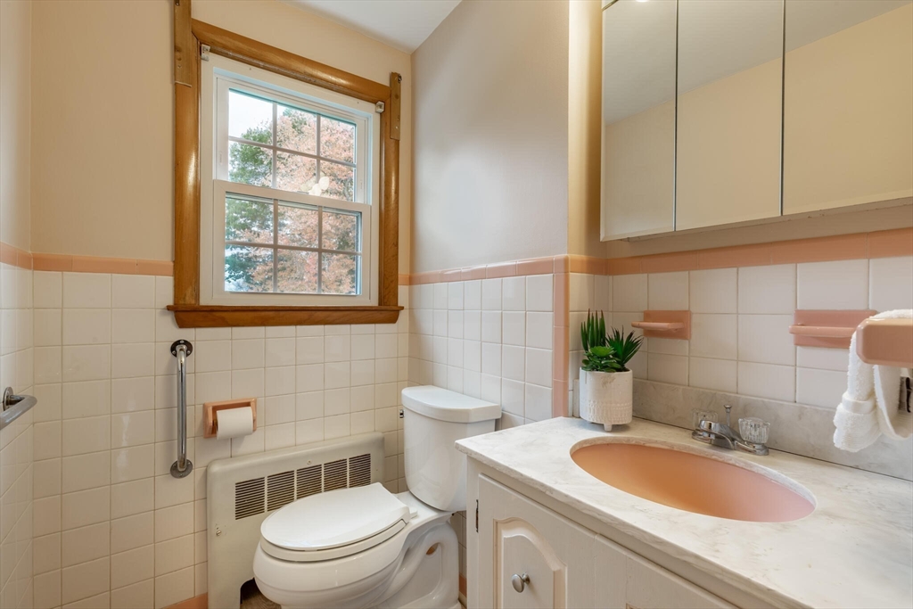 6 Longview Road Chelmsford, MA 01824 - Photo 19 of 40 a bathroom with a granite countertop toilet a sink and a window