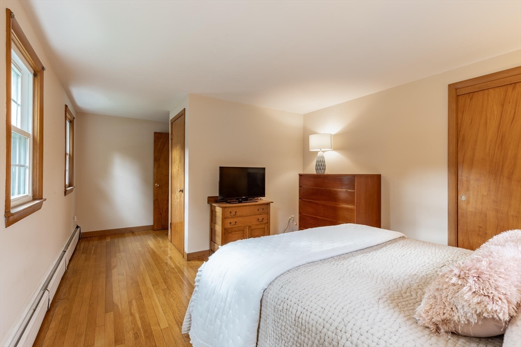 6 Longview Road Chelmsford, MA 01824 - Photo 25 of 40 a bedroom with a bed and a flat screen tv