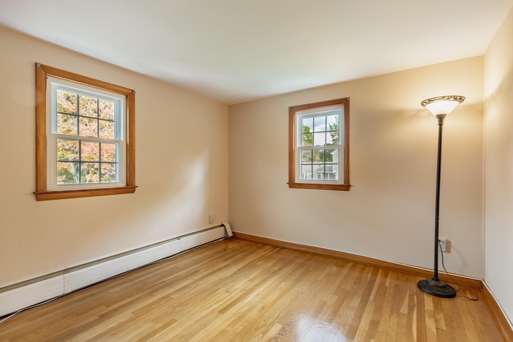 6 Longview Road Chelmsford, MA 01824 - Photo 26 of 40 a view of an empty room with wooden floor and a window