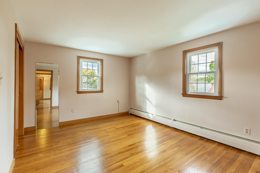 6 Longview Road Chelmsford, MA 01824 - Photo 28 of 40 a view of an empty room with wooden floor and a window