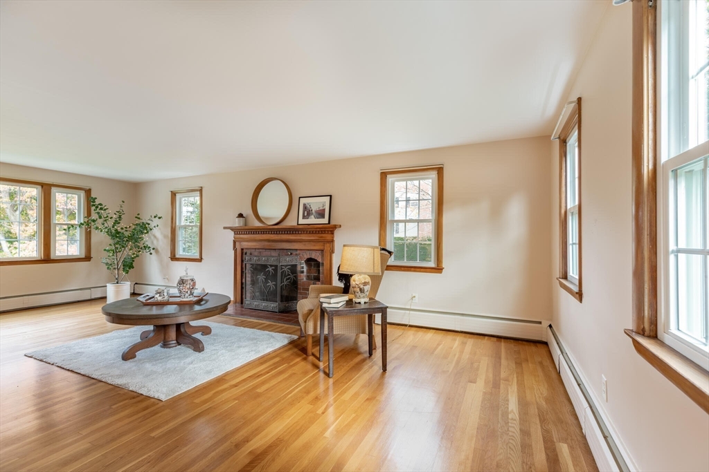 6 Longview Road Chelmsford, MA 01824 - Photo 8 of 40 a living room with fireplace furniture wooden floor and a table