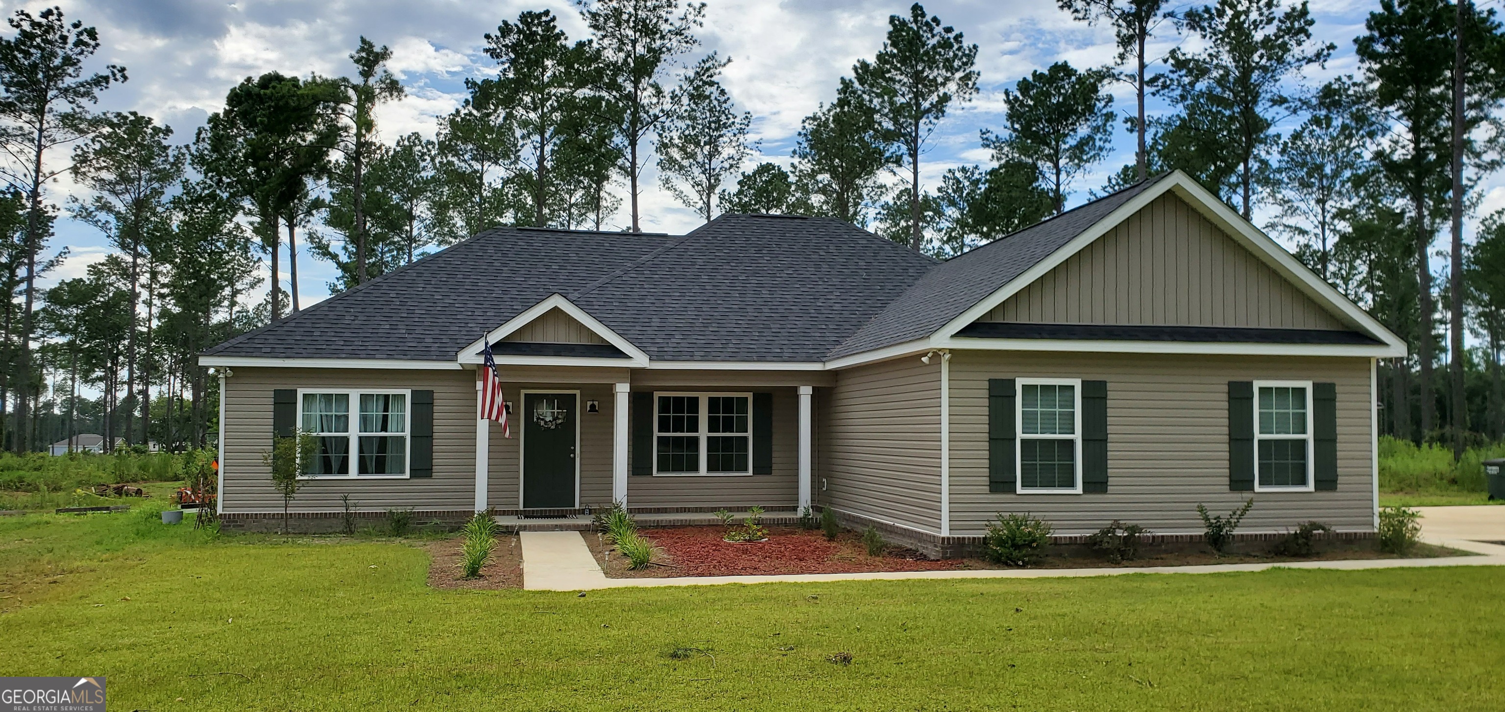 a front view of a house with a yard