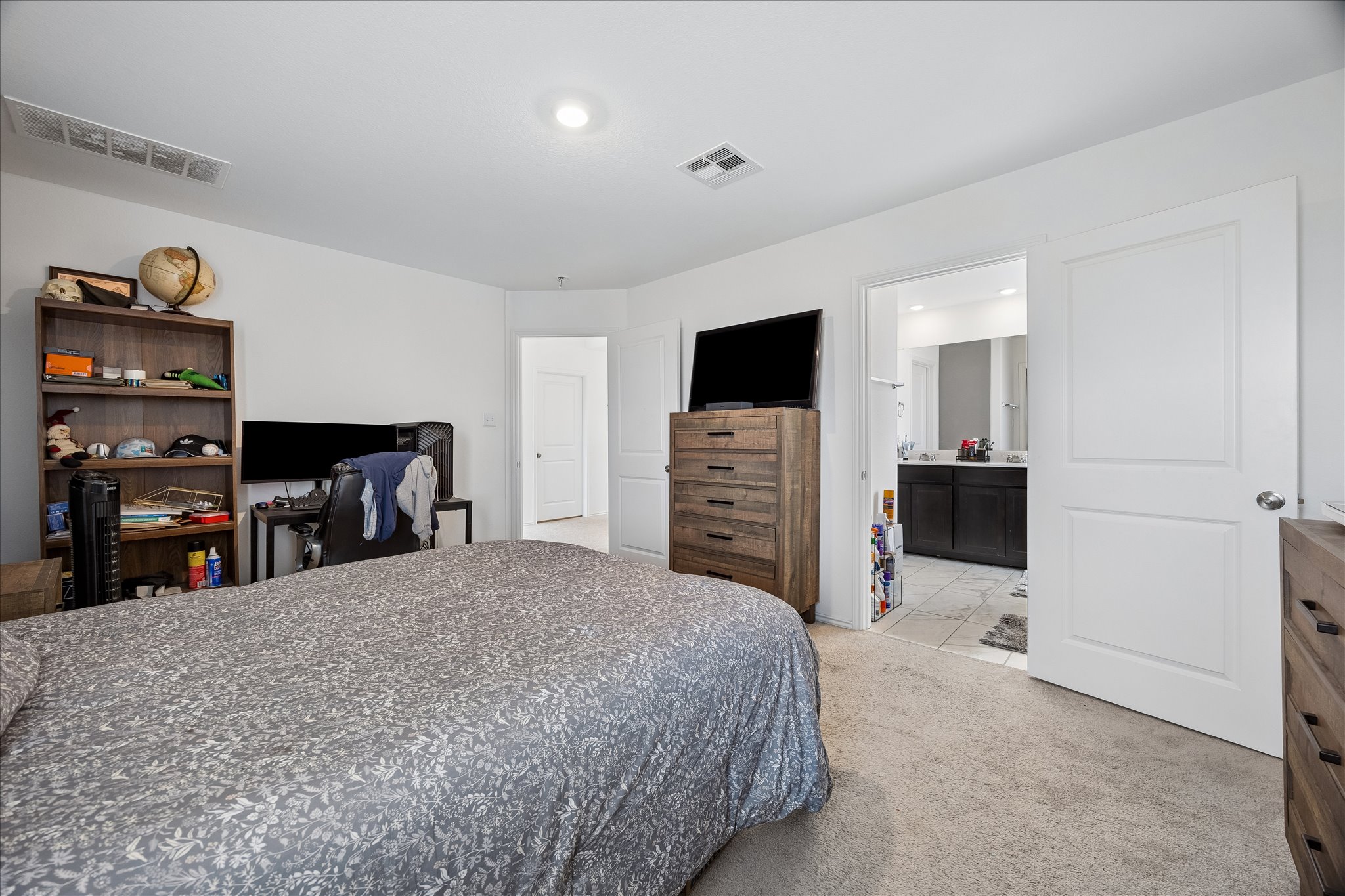 217 Canley Loop Hutto, TX 78634 - Photo 20 of 36 A comfortable bedroom suite provides access to a private, well-appointed bathroom.