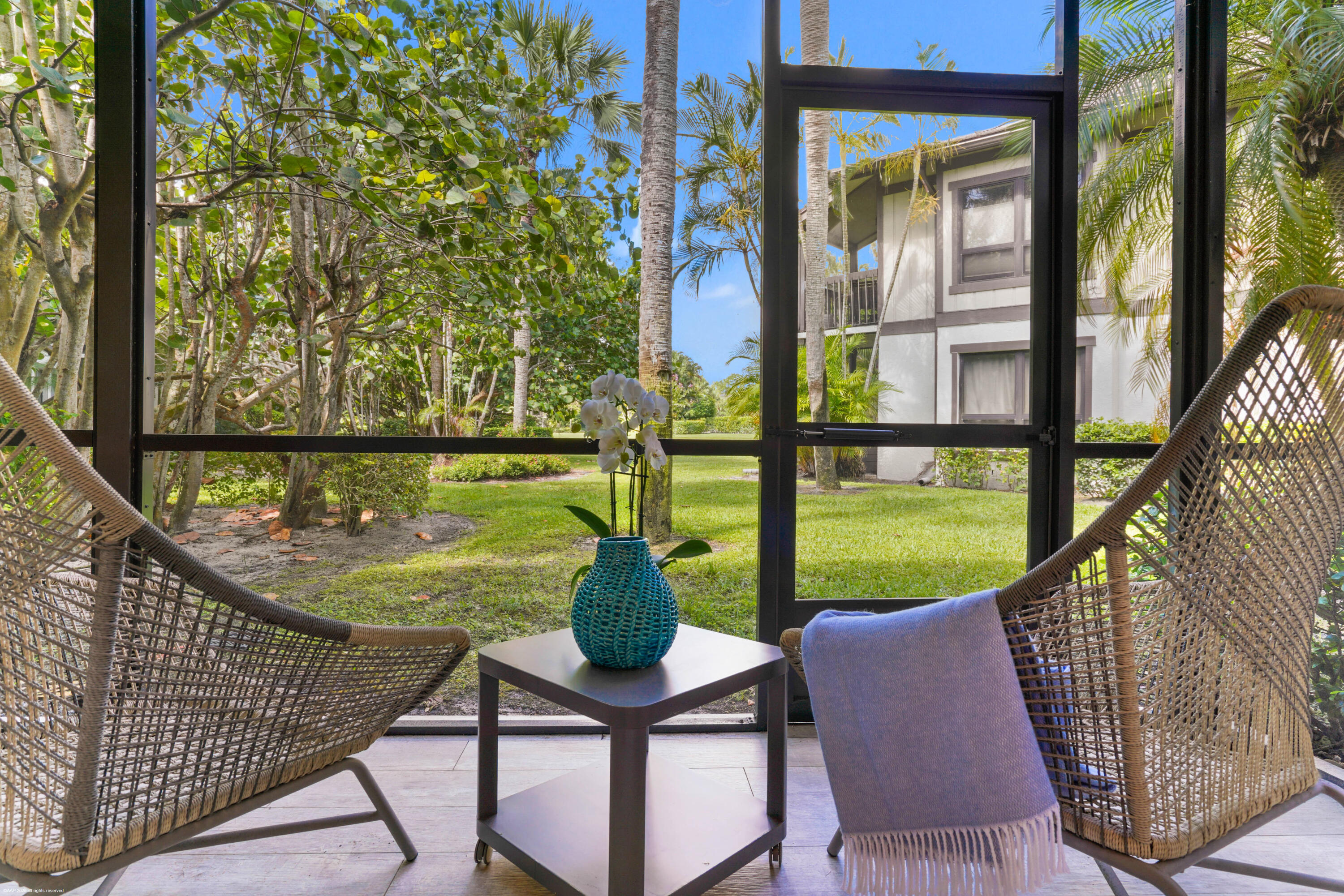 13334 Polo Club Road, Unit 234 Wellington, FL 33414 - Photo 20 of 41 a view of a chair and tables in the balcony