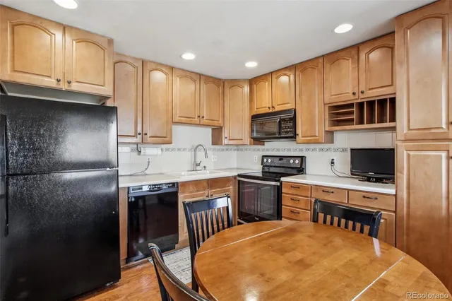 a kitchen with stainless steel appliances granite countertop a stove a sink a microwave and a refrigerator
