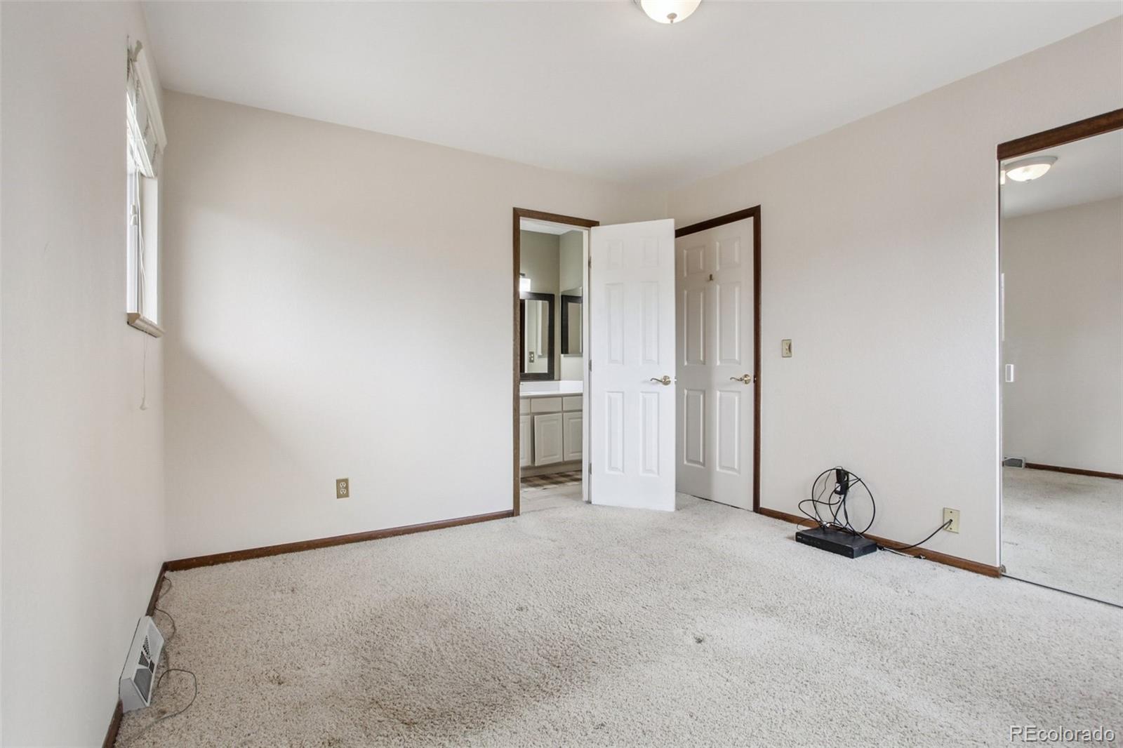 6689 South Delaware Street Littleton, CO 80120 - Photo 17 of 25 an empty room with closet and mirror