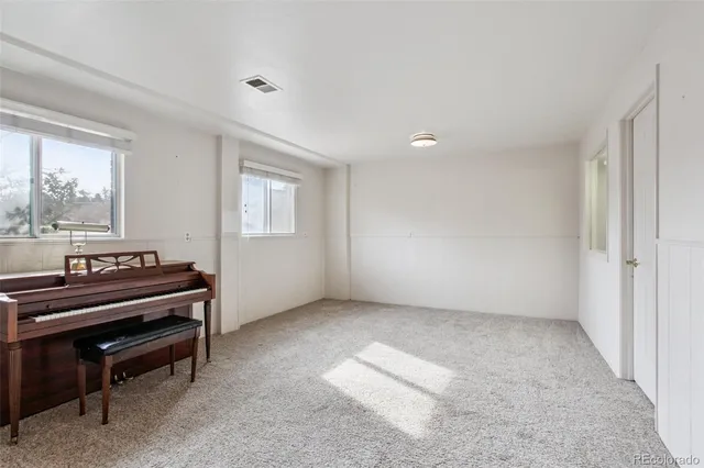 a view of an empty room with a piano