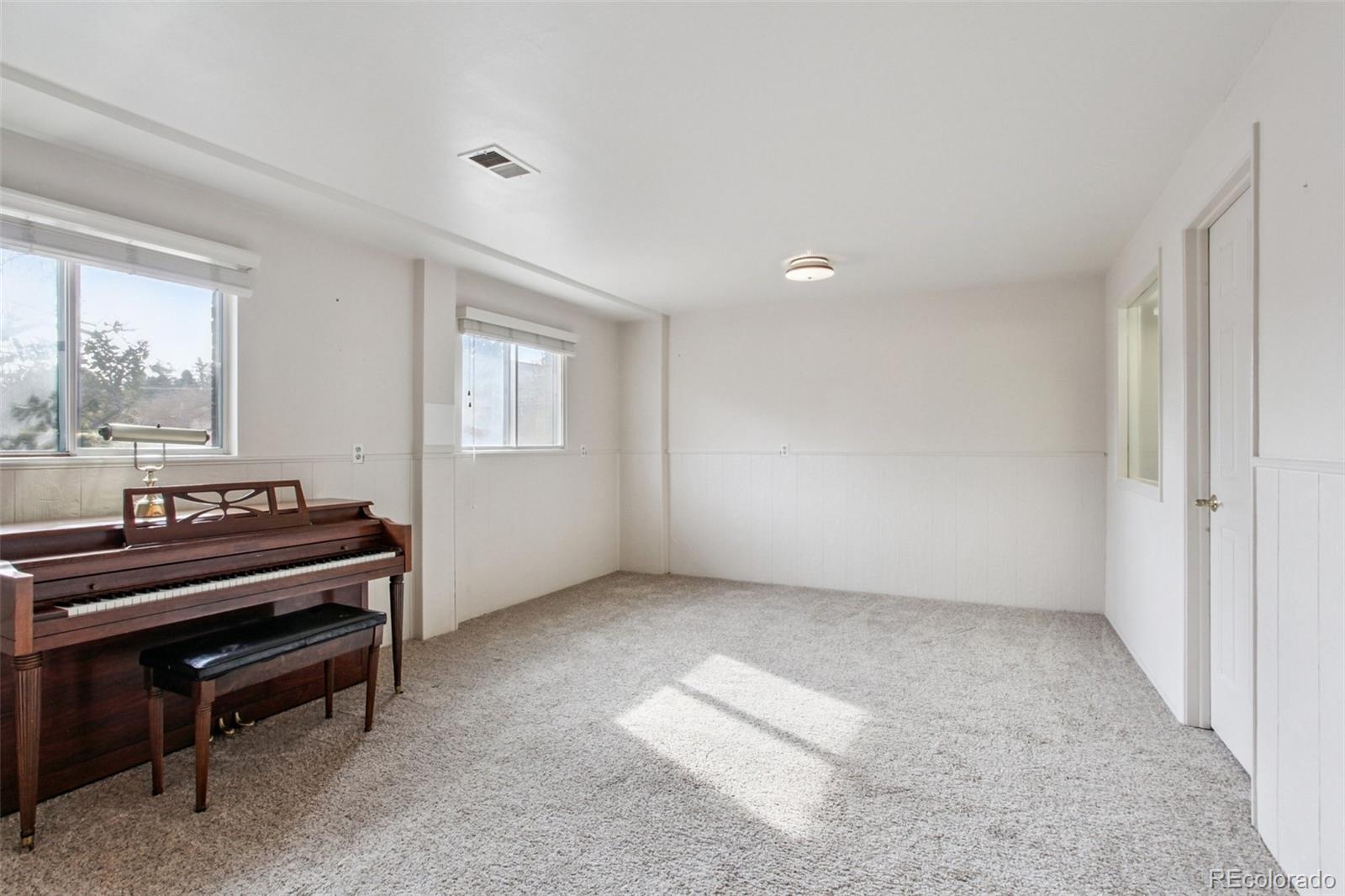 6689 South Delaware Street Littleton, CO 80120 - Photo 19 of 25 a view of an empty room with a piano