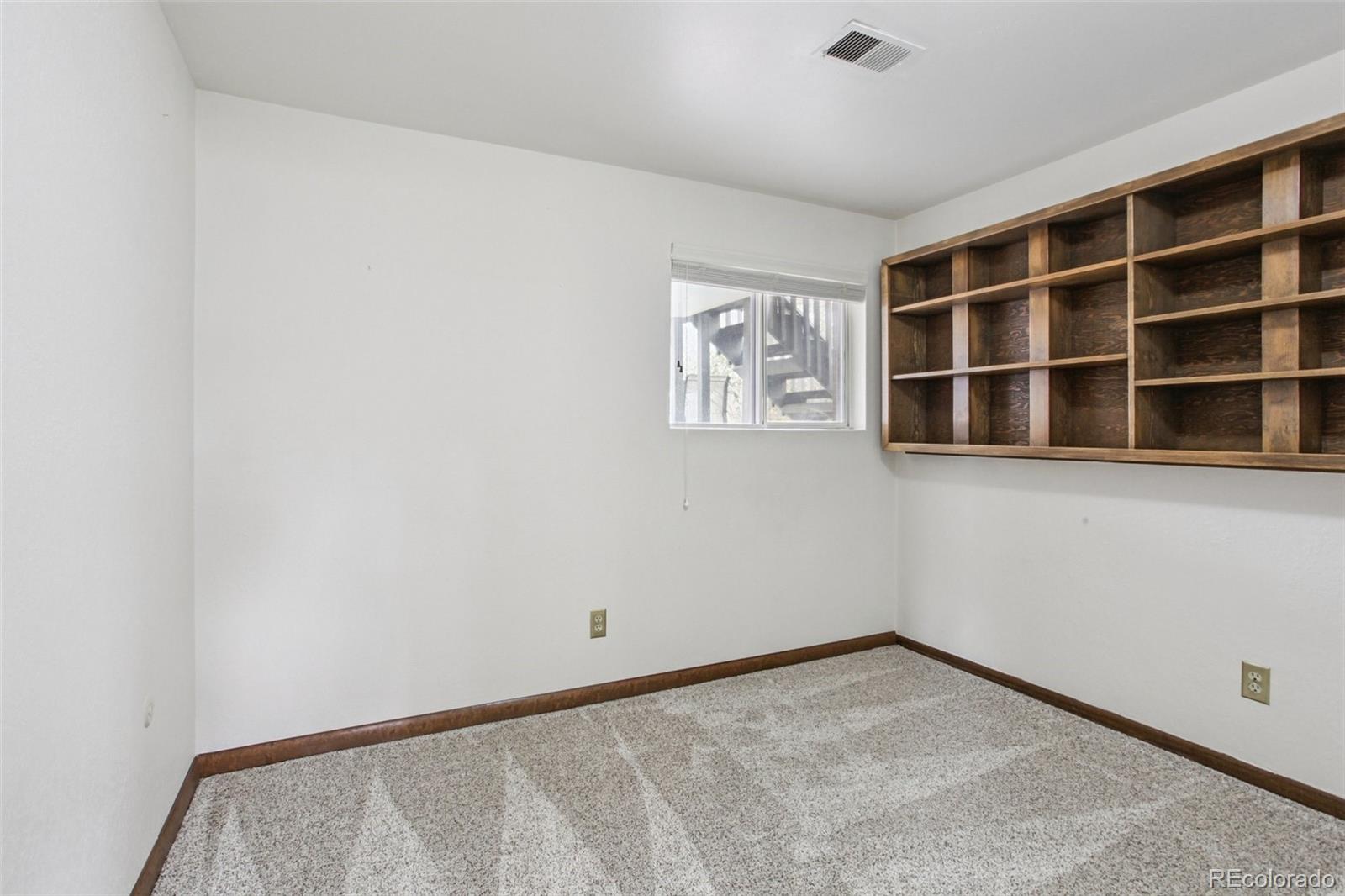 6689 South Delaware Street Littleton, CO 80120 - Photo 22 of 25 a view of an empty room with a window