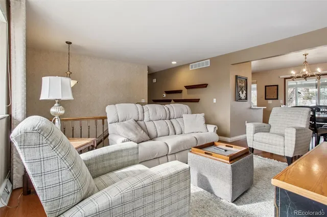 a living room with furniture and a lamp