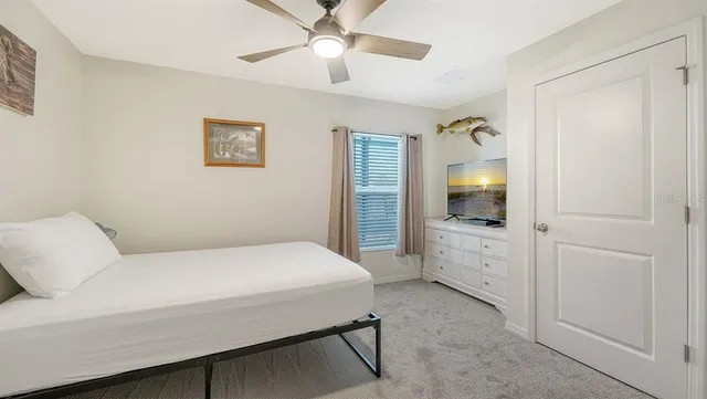 a bedroom with a large bed and a chandelier