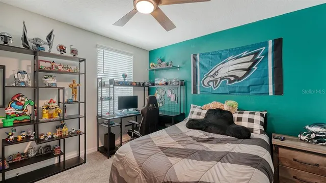 a bedroom with a bed and a bookshelf