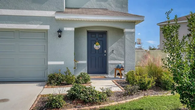 a front view of a house with plants
