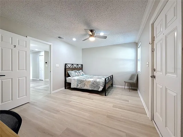 a bedroom with a bed and a chandelier