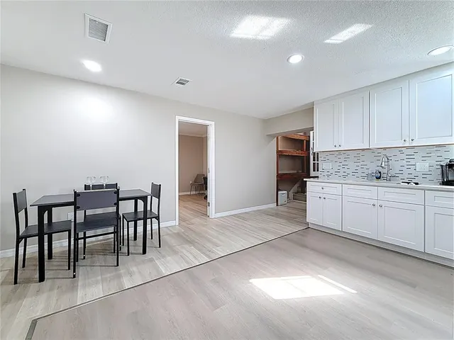 a kitchen with stainless steel appliances granite countertop a refrigerator sink and stove
